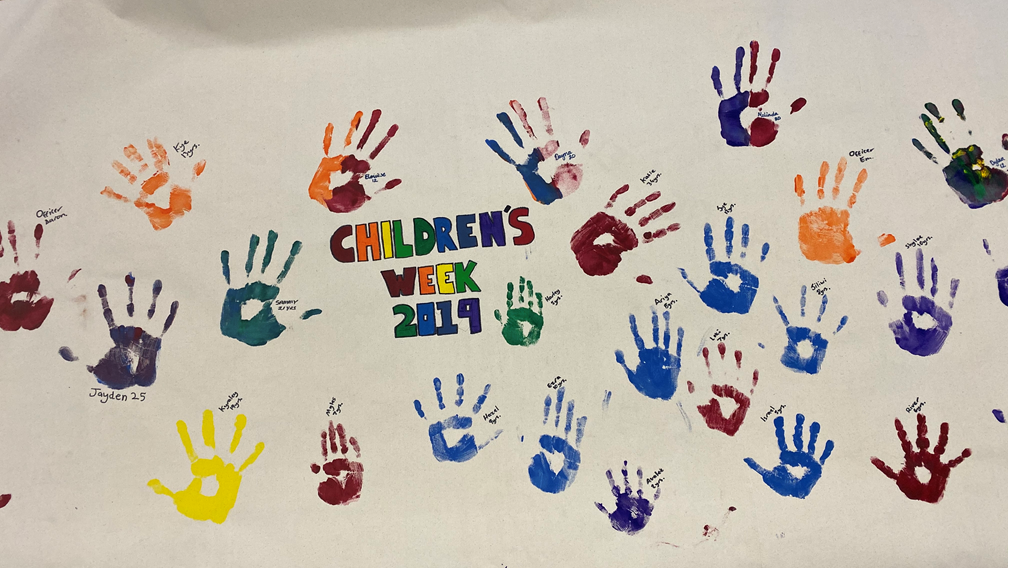 Coloured handprints on poster